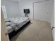 Neutral bedroom features a comfortable bed and double closet for ample storage space at 200 Citrine Loop, Kissimmee, FL 34758