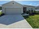 Charming single-story home with a well-maintained lawn and a two-car garage at 200 Citrine Loop, Kissimmee, FL 34758