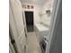 Efficient laundry area with washer and dryer, shelving, and easy access to the garage at 200 Citrine Loop, Kissimmee, FL 34758