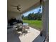 Back patio with ceiling fan and outdoor seating, overlooking the large grassy backyard at 200 Citrine Loop, Kissimmee, FL 34758