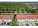 Aerial perspective shows a community next to a highway with a lot of tall green trees as a backdrop at 2000 Greenbriar Ter, Davenport, FL 33837