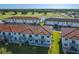 Gorgeous aerial view of community residences and sprawling golf course, with lake and lush landscaping at 2000 Greenbriar Ter, Davenport, FL 33837