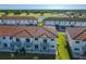 Townhome community from above, showcasing the red tile roofs, green lawns, and proximity to a golf course at 2000 Greenbriar Ter, Davenport, FL 33837