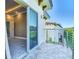 Balcony features a tile floor and a metal railing next to a sliding glass door to interior space at 2000 Greenbriar Ter, Davenport, FL 33837