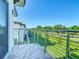 Balcony features a view of the lawn and landscaping with metal railing at 2000 Greenbriar Ter, Davenport, FL 33837