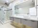 Modern bathroom showcasing a double sink vanity, glass shower, and elegant countertops at 2000 Greenbriar Ter, Davenport, FL 33837