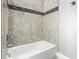 The bathtub shower combo is highlighted by stylish decorative stone at 2000 Greenbriar Ter, Davenport, FL 33837
