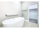 Luxurious bathroom featuring a modern freestanding tub and access to walk-in closet at 2000 Greenbriar Ter, Davenport, FL 33837