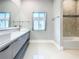 This bathroom has double sinks, quartz counters and tub shower combo at 2000 Greenbriar Ter, Davenport, FL 33837