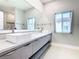 Bathroom features double sinks, quartz counters, and a large mirror at 2000 Greenbriar Ter, Davenport, FL 33837