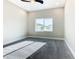 Bright bedroom with large window offering neighborhood views and neutral carpet at 2000 Greenbriar Ter, Davenport, FL 33837