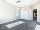 Bright bedroom featuring gray carpet, natural light, and a closet with sliding doors at 2000 Greenbriar Ter, Davenport, FL 33837