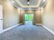 Spacious carpeted bedroom with natural light, tray ceiling, and a sliding glass door to balcony at 2000 Greenbriar Ter, Davenport, FL 33837