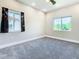 Bedroom featuring neutral-colored carpet, two windows, and a ceiling fan at 2000 Greenbriar Ter, Davenport, FL 33837