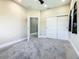 Neutral-colored bedroom featuring modern closet doors and ensuite access at 2000 Greenbriar Ter, Davenport, FL 33837