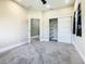 Neutral-colored bedroom featuring modern closet doors and ensuite access at 2000 Greenbriar Ter, Davenport, FL 33837