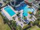 Beautiful aerial view of community pool featuring a lazy river and splash area at 2000 Greenbriar Ter, Davenport, FL 33837