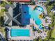 Stunning bird's eye view of the community's main pool and splashpad featuring plenty of lounge seating at 2000 Greenbriar Ter, Davenport, FL 33837