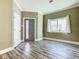 Inviting entryway with wood-look floors, neutral paint, and modern door offers a clean aesthetic at 2000 Greenbriar Ter, Davenport, FL 33837