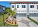 Beautiful modern townhome featuring a red tile roof, glass garage door, and well-manicured landscaping at 2000 Greenbriar Ter, Davenport, FL 33837