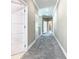 Bright hallway with neutral paint, carpet flooring, crown molding, and paneled doors at 2000 Greenbriar Ter, Davenport, FL 33837