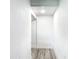 Hallway with white walls, white trim, and gray wood-look flooring at 2000 Greenbriar Ter, Davenport, FL 33837
