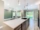 Kitchen island offering seating and a view of the backyard, stainless steel appliances, natural light at 2000 Greenbriar Ter, Davenport, FL 33837