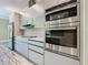Modern kitchen with stainless steel appliances, sleek cabinets, and quartz countertops offers contemporary style at 2000 Greenbriar Ter, Davenport, FL 33837