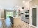 Modern kitchen with island seating, stainless steel appliances, and sleek cabinetry creates a stylish cooking space at 2000 Greenbriar Ter, Davenport, FL 33837