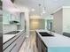 Modern kitchen with sleek cabinetry, stainless steel appliances, and a spacious island with a sink at 2000 Greenbriar Ter, Davenport, FL 33837