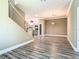 Open concept living space with wood-look floors, stairs, and modern finishes offers a spacious feel at 2000 Greenbriar Ter, Davenport, FL 33837
