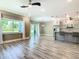 Open living space with luxury vinyl floors and a large window providing ample natural light at 2000 Greenbriar Ter, Davenport, FL 33837