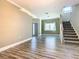 Spacious living room with wood-look floors, stairs, and modern lighting offers a comfortable layout at 2000 Greenbriar Ter, Davenport, FL 33837