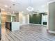 Modern open-plan living space with stainless steel appliances and a large kitchen island at 2000 Greenbriar Ter, Davenport, FL 33837