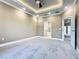 Spacious main bedroom boasts tray ceiling, ceiling fan, and ensuite bathroom access at 2000 Greenbriar Ter, Davenport, FL 33837