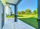 Covered patio featuring tile floors, stone columns and a great view of the lush green lawn at 2000 Greenbriar Ter, Davenport, FL 33837
