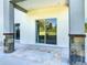 The patio features tile floors, stone columns, large sliding glass doors, and a view of the backyard at 2000 Greenbriar Ter, Davenport, FL 33837