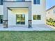 Covered patio featuring stone pillars, concrete pavers, and sliding glass doors enhances outdoor living at 2000 Greenbriar Ter, Davenport, FL 33837