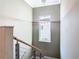 Contemporary stairwell features modern railing, window and chandelier lighting fixture at 2000 Greenbriar Ter, Davenport, FL 33837