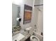 Bathroom with granite countertop vanity, shower, and decorative art at 212 Grouper Ct, Poinciana, FL 34759