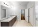 Modern bathroom boasts double sinks, granite counters and an open doorway at 212 Grouper Ct, Poinciana, FL 34759
