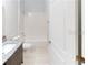 Bright bathroom with a white shower and granite counters at 212 Grouper Ct, Poinciana, FL 34759