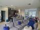 Spacious living room featuring modern open layout connected to kitchen and dining area at 212 Grouper Ct, Poinciana, FL 34759