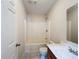 A clean, well-lit bathroom with a shower and tub combination and tile flooring at 2409 E Magnolia St, Lakeland, FL 33801