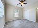 An empty bedroom features luxury vinyl plank flooring, light gray walls, and a large, bright window at 2409 E Magnolia St, Lakeland, FL 33801