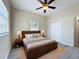 Comfortable bedroom with a wooden bed frame, ceiling fan, light gray walls and luxury vinyl plank flooring at 2409 E Magnolia St, Lakeland, FL 33801
