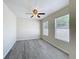 Bright empty bedroom with modern LVP flooring, two windows and a ceiling fan at 2409 E Magnolia St, Lakeland, FL 33801