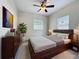 Bedroom with warm tones, wooden furniture, artwork, and windows for natural light at 2409 E Magnolia St, Lakeland, FL 33801