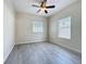 Bright bedroom with a ceiling fan, two windows, and vinyl flooring at 2409 E Magnolia St, Lakeland, FL 33801