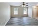 Spacious bedroom with light-colored walls, two windows, wood-look flooring, and a ceiling fan at 2409 E Magnolia St, Lakeland, FL 33801